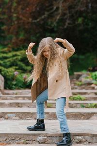 Seven year old girl makes faces in the spring in the park