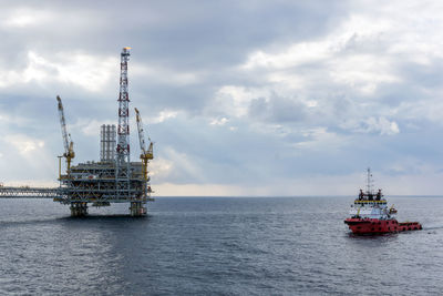 An anchor handling tug boat maneuvering near an oil platform at offshore terengganu oil field