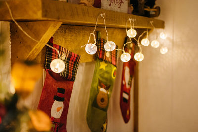 Close-up of illuminated christmas lights hanging on wood