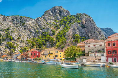 Scenic view of the old city of omis in croatia with the adriatic sea and mountains with pine trees 