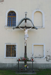 Street light by statue against building