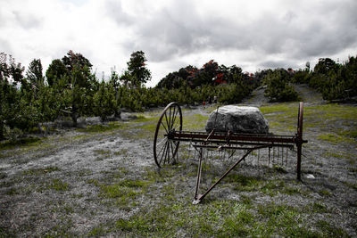 Metallic structure on field against sky