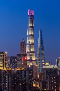 Illuminated buildings against sky at night