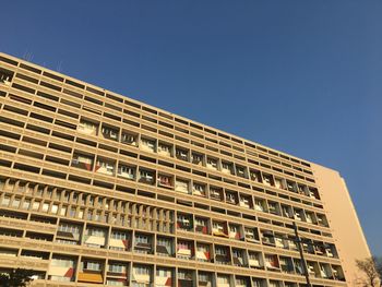 Low angle view of building against clear blue sky