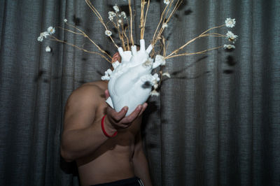 Rear view of woman with arms raised