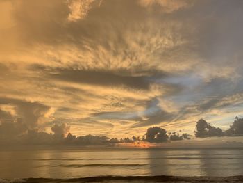 Scenic view of dramatic sky over sea during sunset