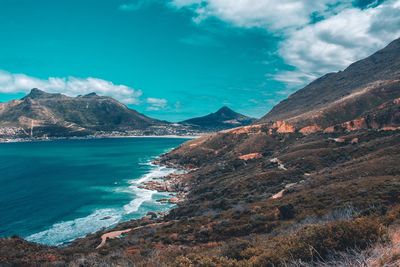 Scenic view of sea and mountains against sky