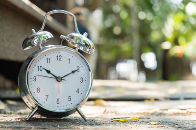 Close-up of alarm clock on footpath