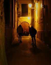 Rear view of silhouette people walking in corridor