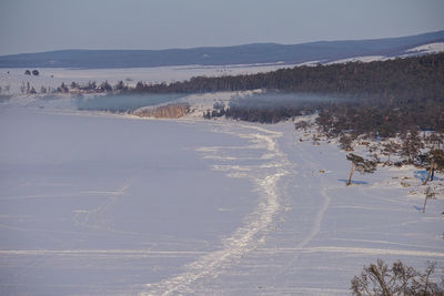 Scenic view of landscape against sky during winter