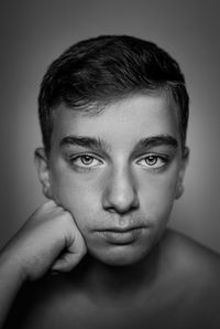 Close-up portrait of shirtless young boy .