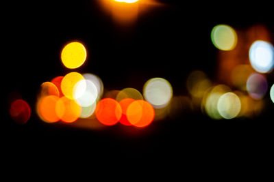 Defocused image of illuminated street lights at night