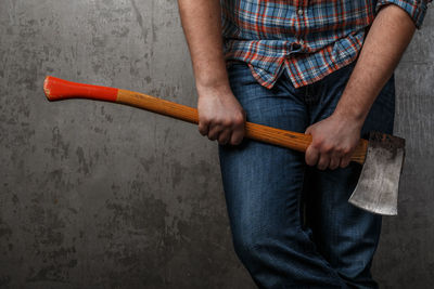 Midsection of man holding knife