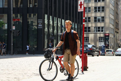 Man riding bicycle on city street