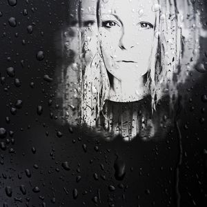 Close-up portrait of wet glass window in rainy season