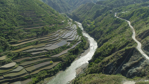 Aerial view of rice terraces and agricultural land on the slopes of the mountains. 