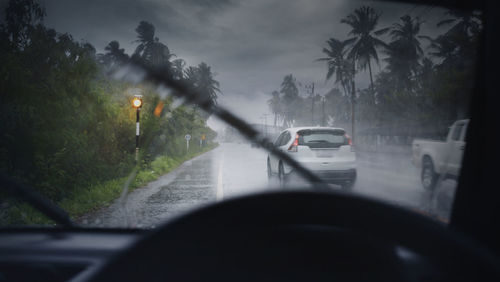 Cars on road seen through car windshield