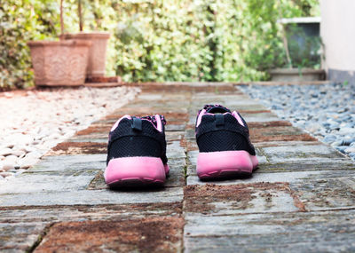 Close-up of shoes on walkway