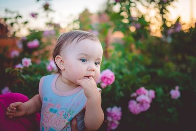 Portrait of cute girl with pink flower