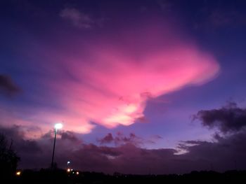 Low angle view of illuminated street light against sky at night