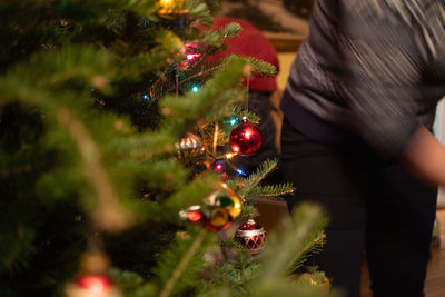 Midsection of illuminated christmas tree