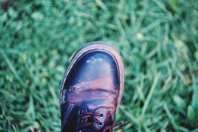 Low section of man wearing shoe