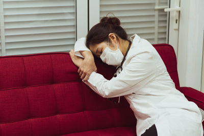 Woman wearing mask sleeping at home