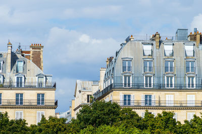 Typical architecture of paris in france. the building roofs are curved and covered in zinc plates