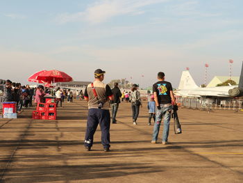 People on street against sky