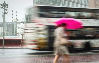 Blurred motion of people walking on road