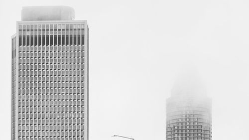 Low angle view of buildings in city against sky