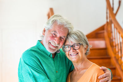 Portrait of smiling couple standing at home