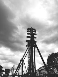 Low angle view of amusement park against sky