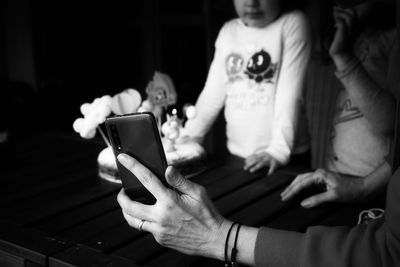 Midsection of woman using mobile phone