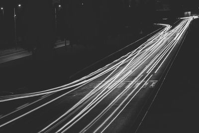 High angle view of light trails on railroad tracks at night