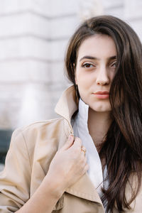 Beautiful young woman standing in city