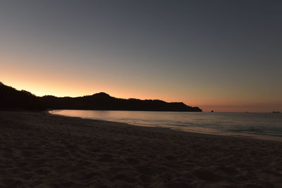 Scenic view of beach at sunset