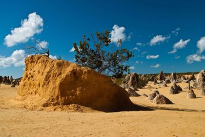 Scenic view of desert against cloudy sky