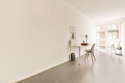 Rear view of woman sitting on floor at home