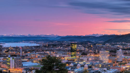 High angle view of illuminated buildings in city during sunset