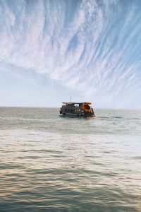 Boat sailing on sea against sky