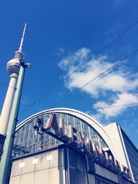 Low angle view of fernsehturm against sky at alexanderplatz in city