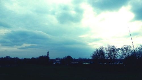 Scenic view of field against cloudy sky