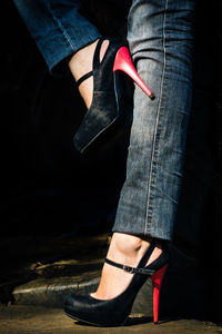 Low section of woman wearing stilettoes standing on floor