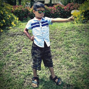 Full length of boy standing on field