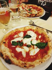 High angle view of pizza served on table