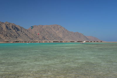 Scenic view of sea against clear blue sky