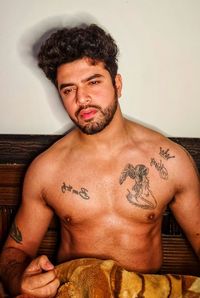 Portrait of shirtless man standing at home