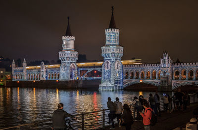 People at illuminated city at night