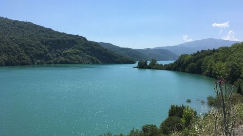 Scenic view of lake against blue sky